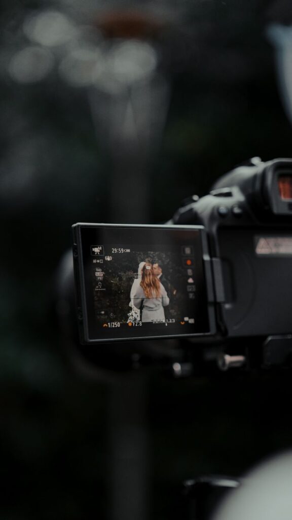 Crafting Captivating Headlines: Your awesome post title goes here Close-up of camera screen showing a couple during wedding photography outdoors.